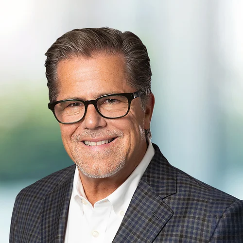 A photo of attorney Dennis Strazulo against a softly blurred office background