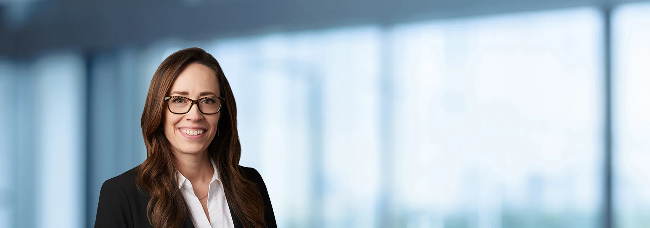 A photo of attorney, Amanda Bryan, against a softly blurred office background