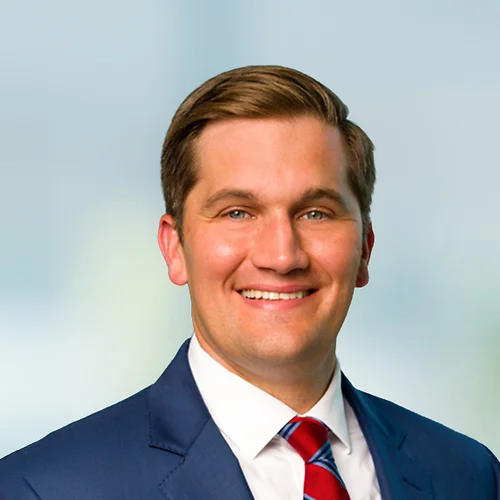 A photo of attorney Quinn Adams against a softly blurred office background