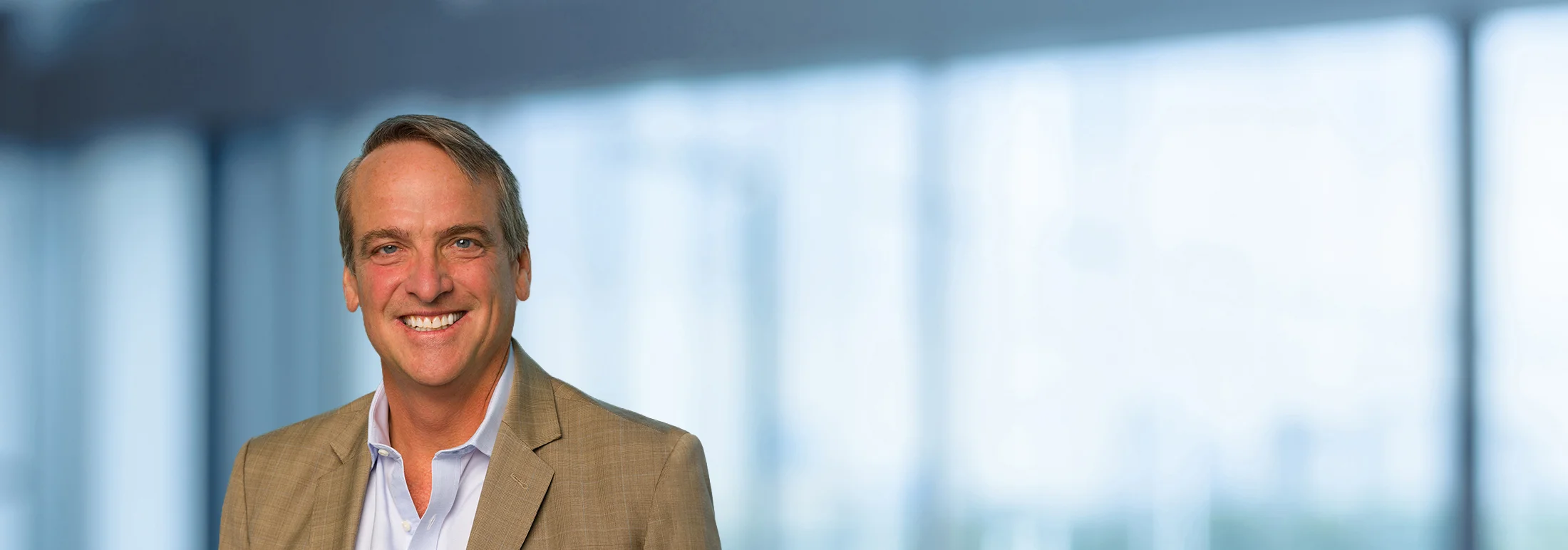 A photo of attorney, Charlie Meyer, against a softly blurred office background