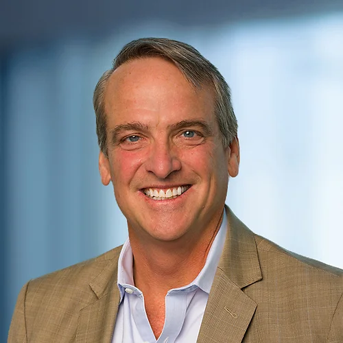 A photo of attorney, Charlie Meyer, against a softly blurred office background