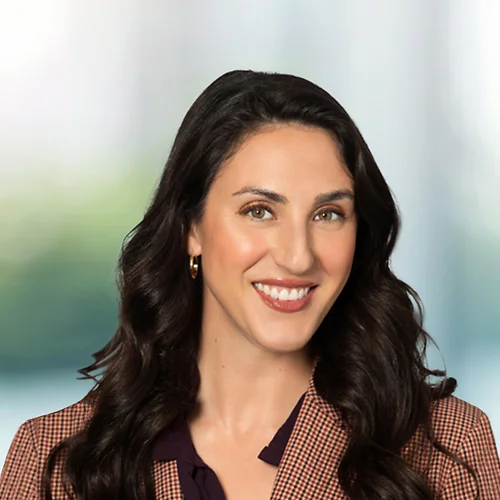 A photo of attorney Thalia Rofos against a softly blurred office background
