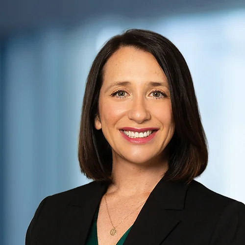 A photo of attorney, Megan Childress, against a softly blurred office background