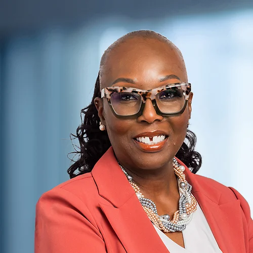 A photo of attorney, Tina Samuel-Priestley, against a softly blurred office background.