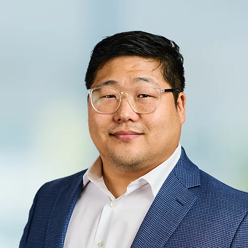 A photo of attorney Peter Lee against a softly blurred office background