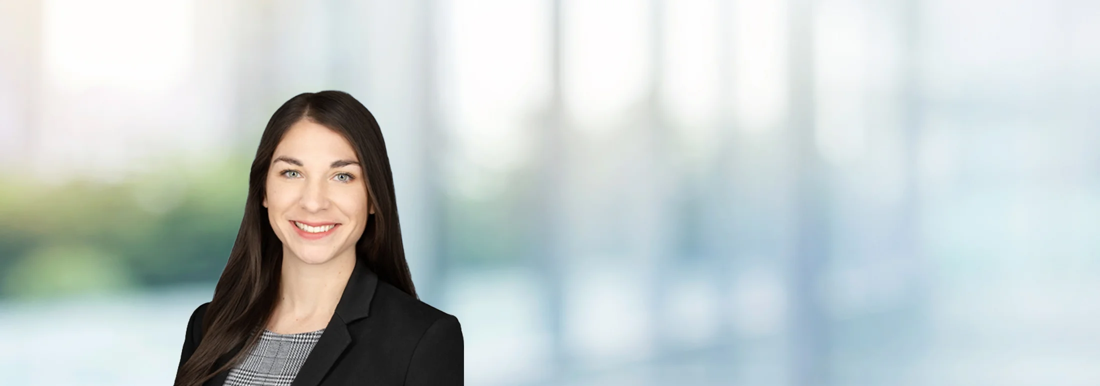 A photo of attorney, Marie Avery, against a softly blurred office background
