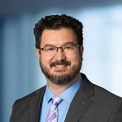 A photo of attorney, Kevin Cleveland, against a softly blurred office background