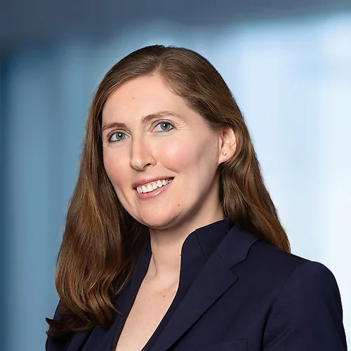 A photo of attorney, Sidorela Deliu-Kerasiotis, against a softly blurred office background