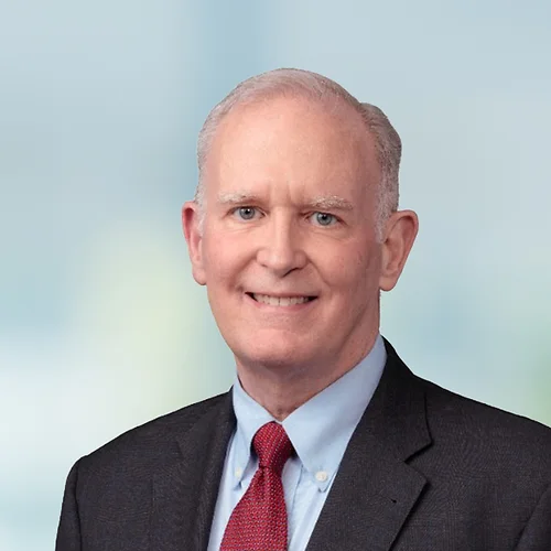 A photo of attorney, Wilhelm Dingler, against a softly blurred office background.