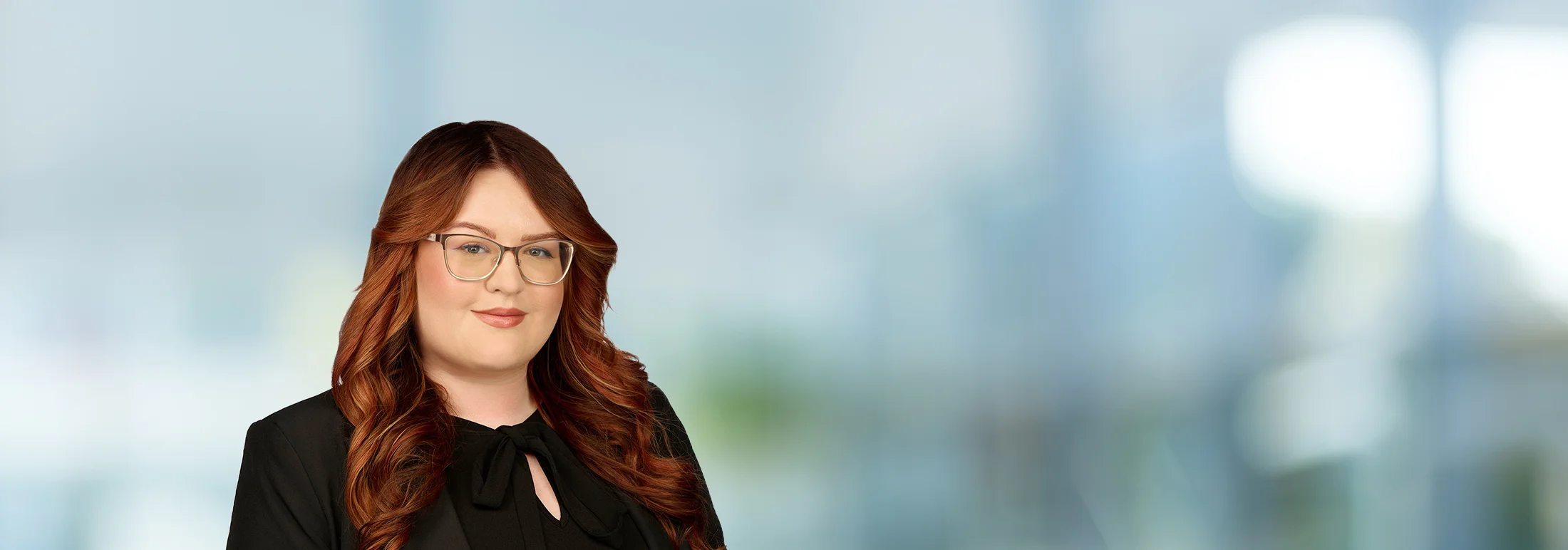 A photo of attorney, Tara McManamy, against a softly blurred office background.