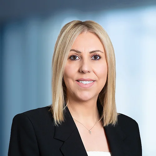 A photo of attorney, Vickie Grasu, against a softly blurred office background