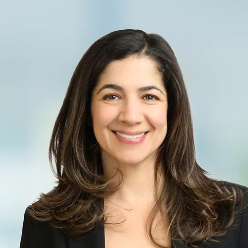A photo of attorney Hillary Weinstein against a softly blurred office background