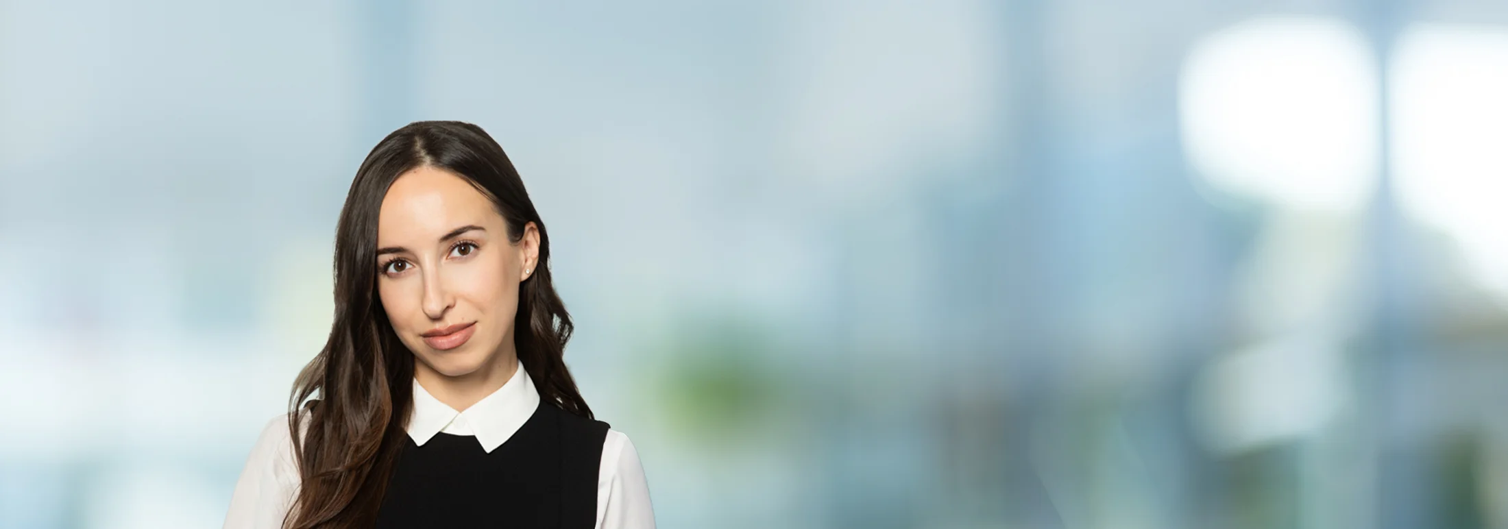 A photo of attorney Alina Goncharova against a softly blurred office background