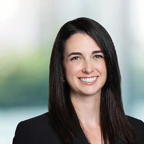A photo of attorney Victoria Danna against a softly blurred office background