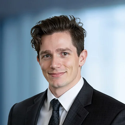 A photo of attorney Dusinh Pokorny against a softly blurred office background