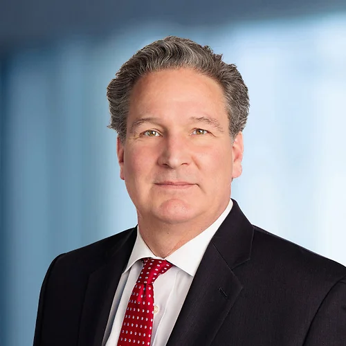 A photo of attorney Tom Grant against a softly blurred office background