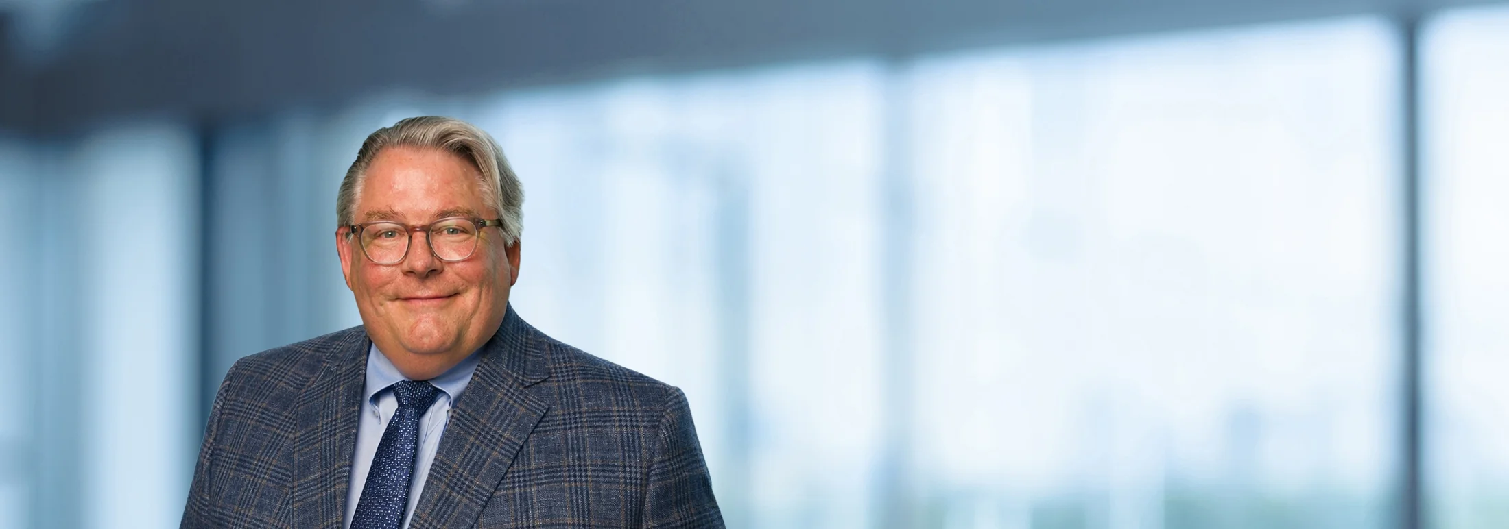 A photo of attorney, Mike Barnsback, against a softly blurred office background.
