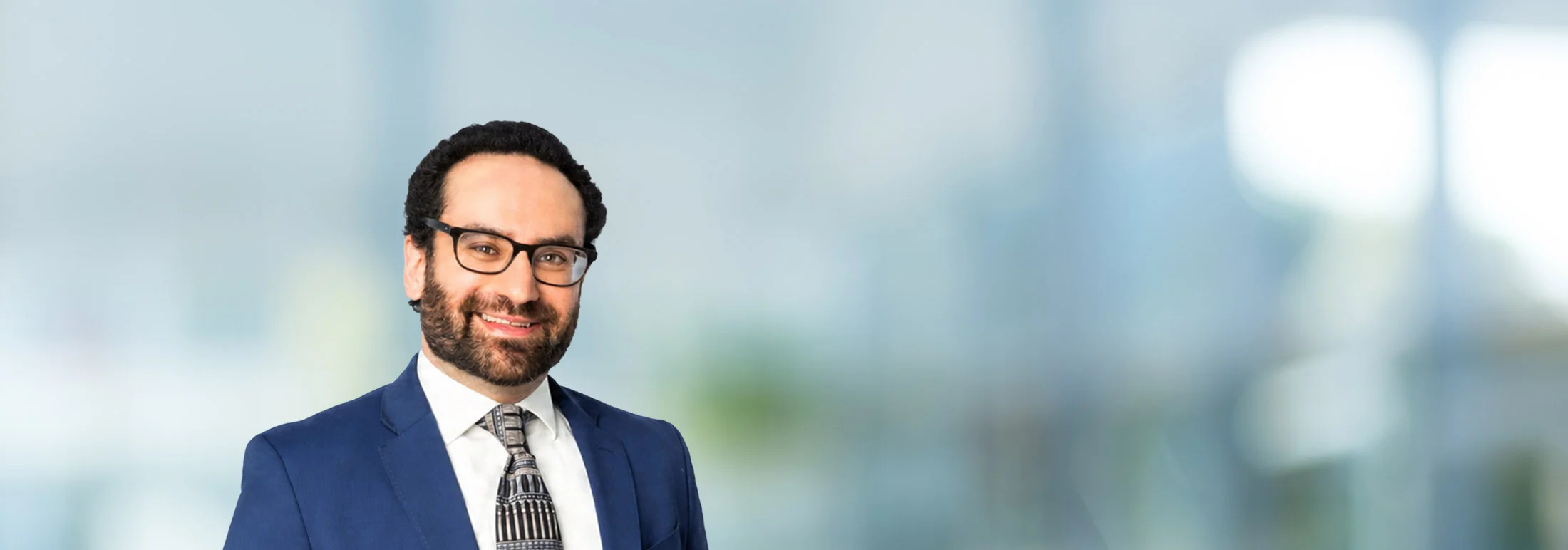 A photo of attorney Ethan Slabosky against a softly blurred office background