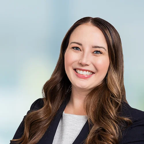 A photo of attorney, Alexa Perivolotis, against a softly blurred office background.