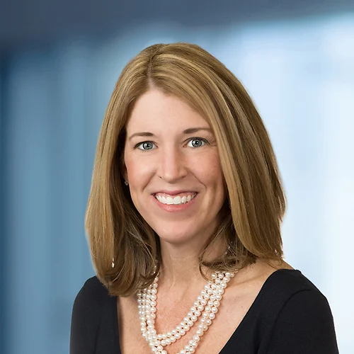 A photo of attorney, Paige Canepari, against a softly blurred office background.