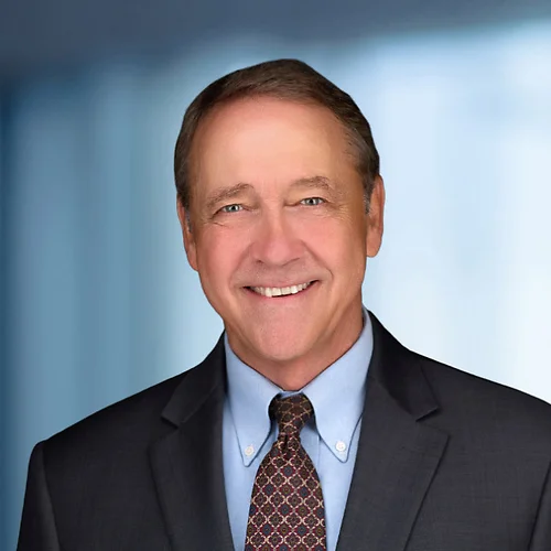 A photo of attorney John Lamb against a softly blurred office background