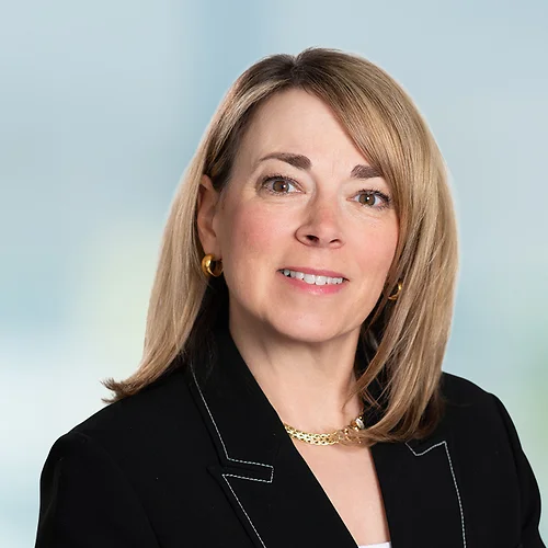 A photo of attorney, Meredith McDonald, against a softly blurred office background.