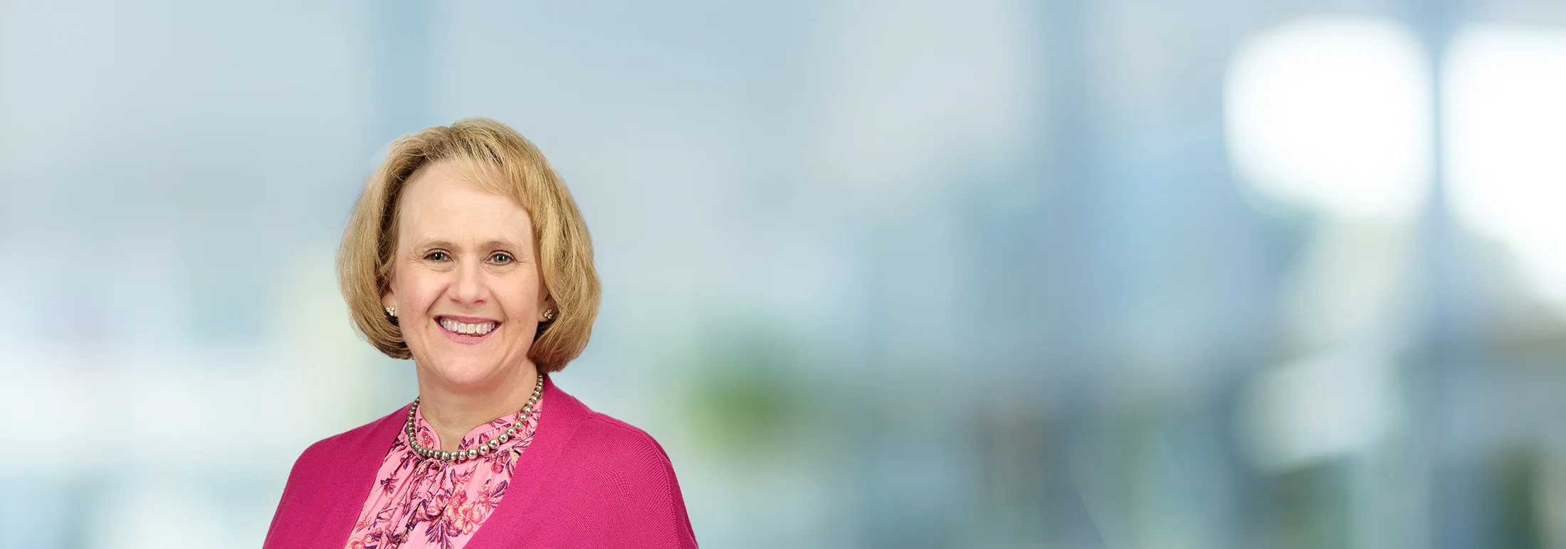 A photo of attorney Jackie Gallagher against a softly blurred office background