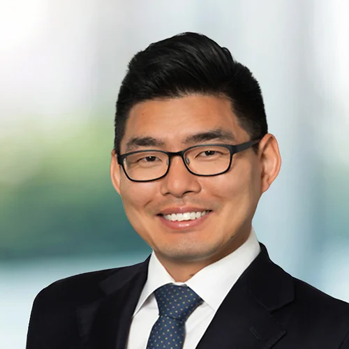 A photo of attorney, Christopher Cho, against a softly blurred office background