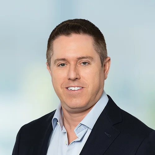 A photo of attorney, Matt Sgnilek, against a softly blurred office background