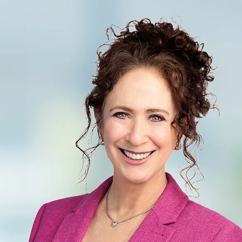 A photo of attorney Joelle Sharman against a softly blurred office background