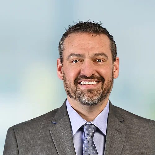 A photo of attorney, Jamey Davidson, against a softly blurred office background.