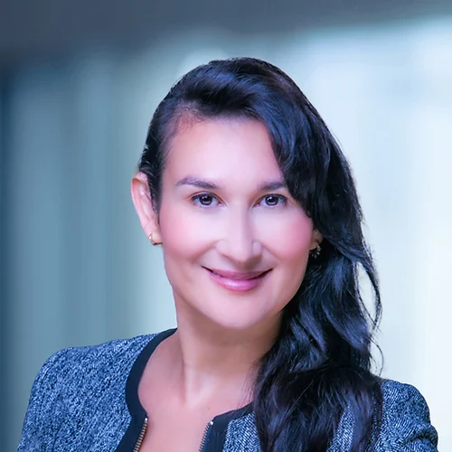 A photo of attorney, Elizabeth Del Cid, against a softly blurred office background