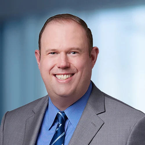 A photo of attorney, Brad Krupicka, against a softly blurred office background