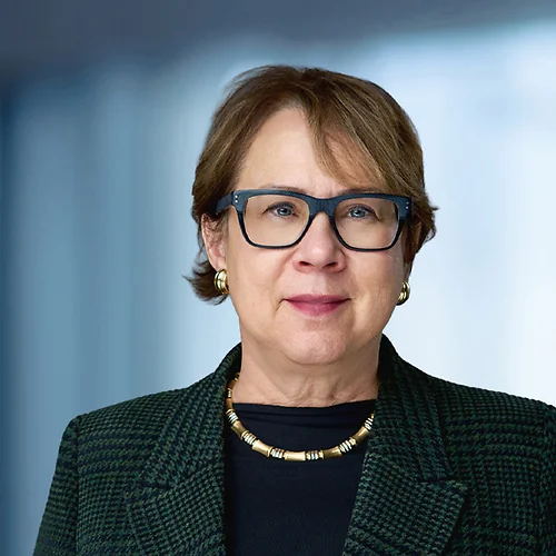 A photo of attorney, Joan McKenna, against a softly blurred office background