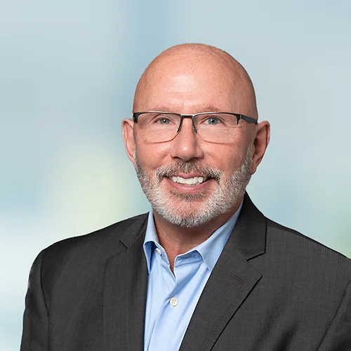 A photo of attorney, Ted Peters, against a softly blurred office background