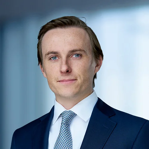 A photo of attorney Maxfield Daley-Watson against a softly blurred office background