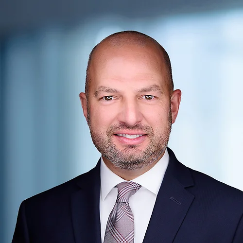 A photo of attorney Dean Falavolito against a softly blurred office background