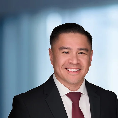 A photo of attorney, Chris Nepacena, against a softly blurred office background