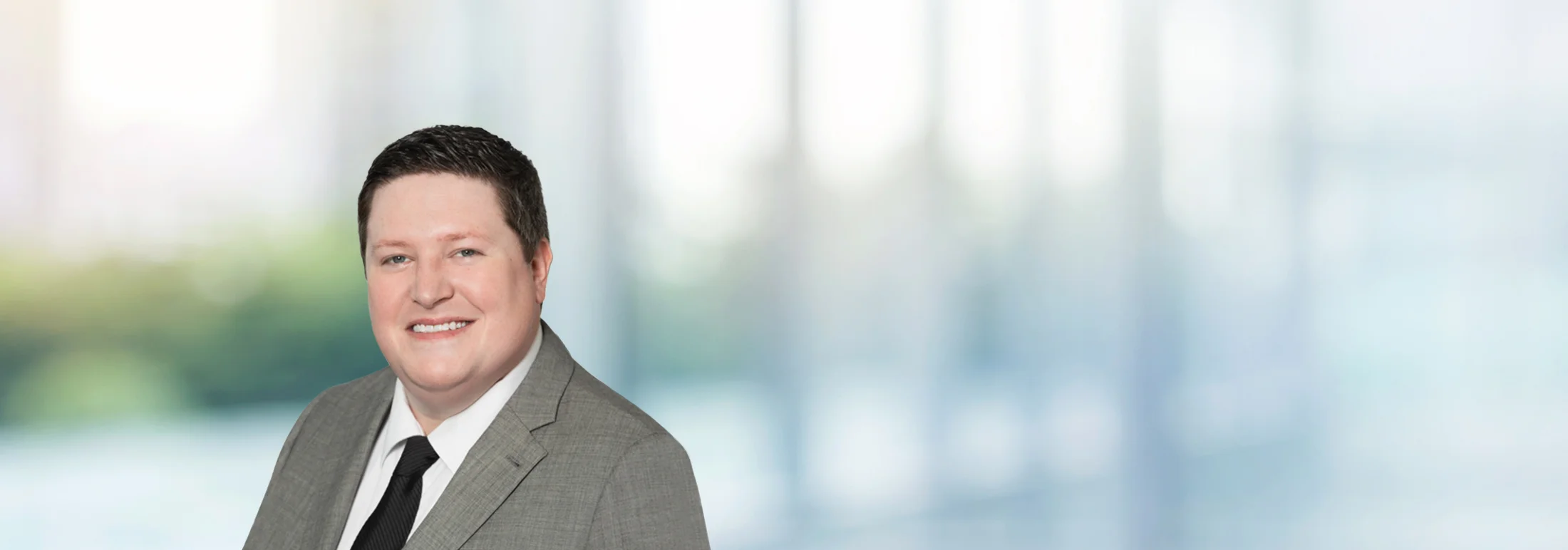 A photo of attorney Matthew Sullivan against a softly blurred office background