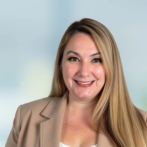 A photo of attorney, Alyson M. Dudkowski, against a softly blurred office background