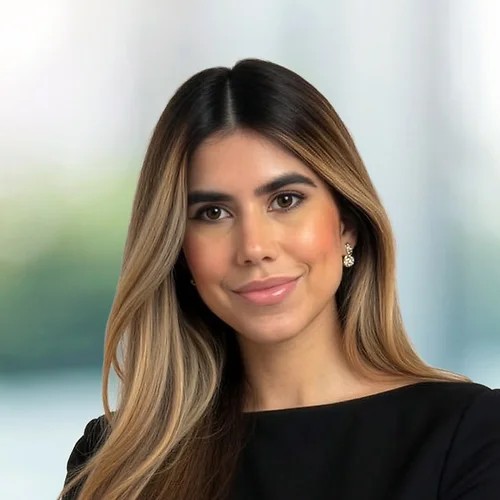 A photo of attorney Nicole Burgos Romero against a softly blurred office background