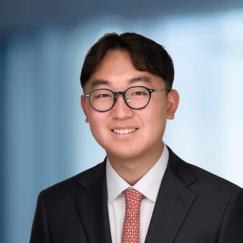 A photo of attorney Chongho Lee against a softly blurred office background