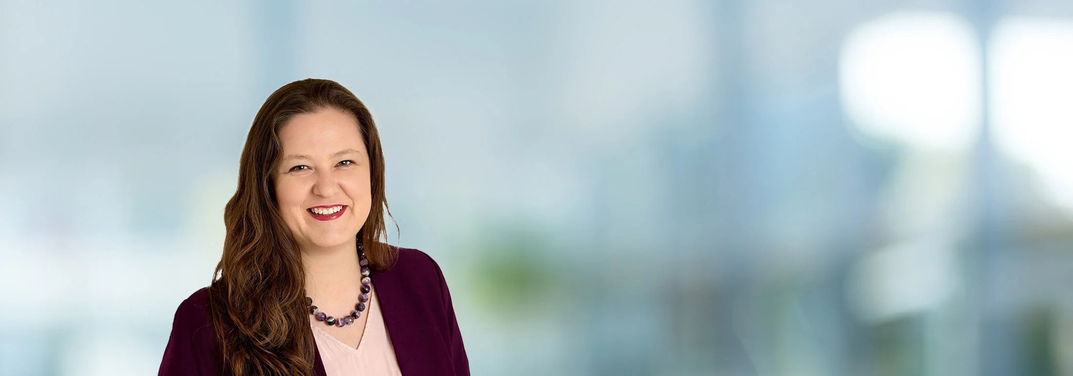 A photo of attorney Breanne Patton against a softly blurred office background