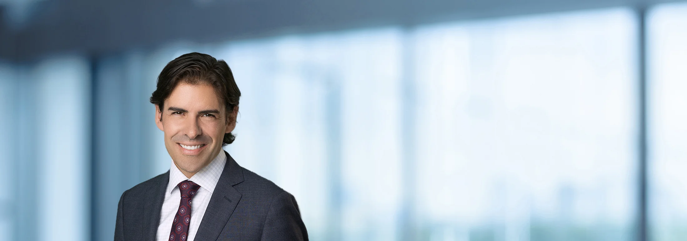 A photo of attorney, Kevin Rasp, against a softly blurred office background.