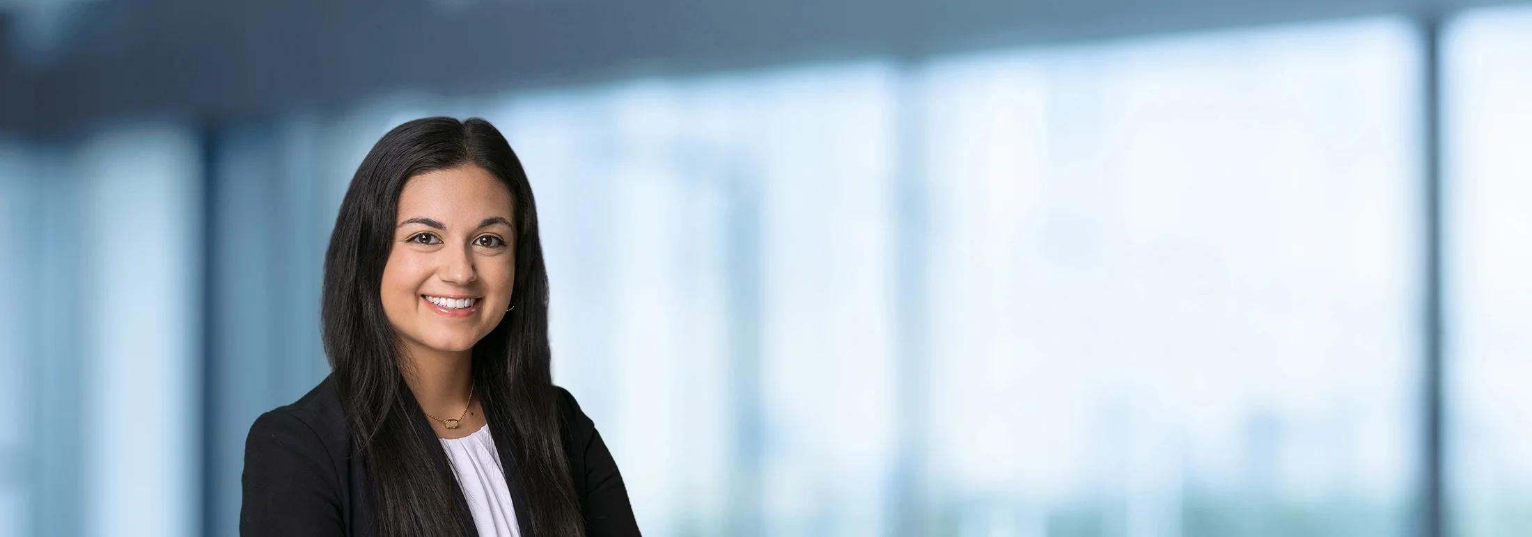 A photo of attorney, Niti Suchdev, against a softly blurred office background.