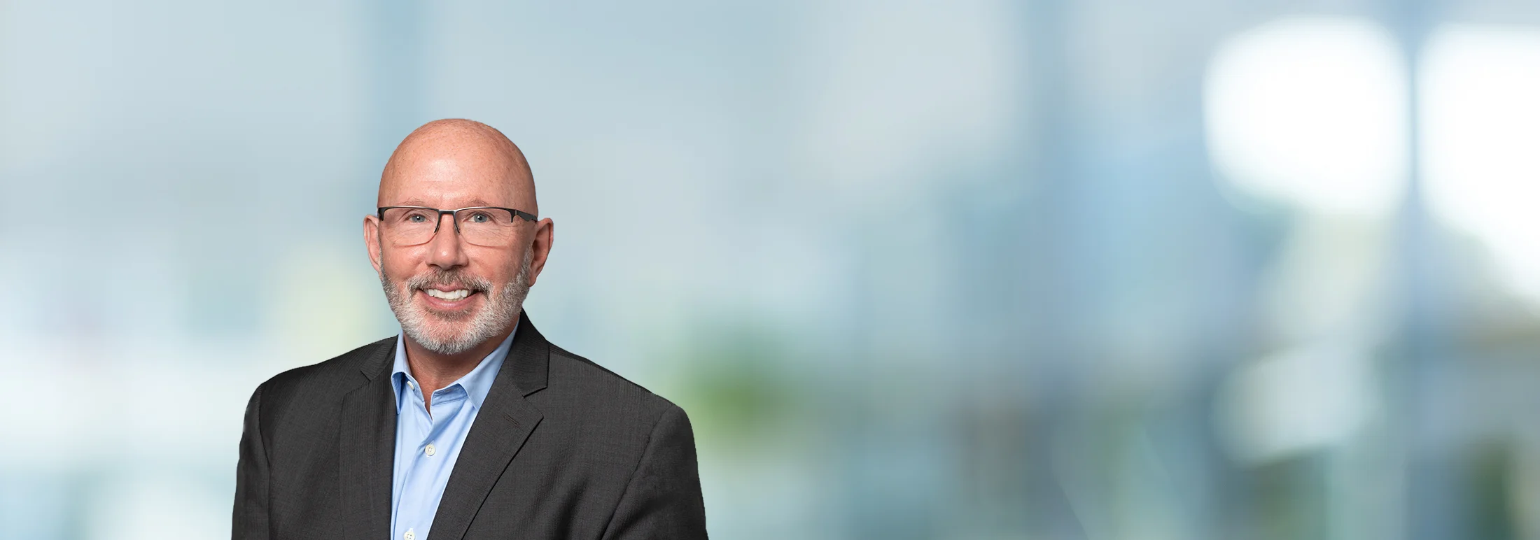 A photo of attorney, Ted Peters, against a softly blurred office background