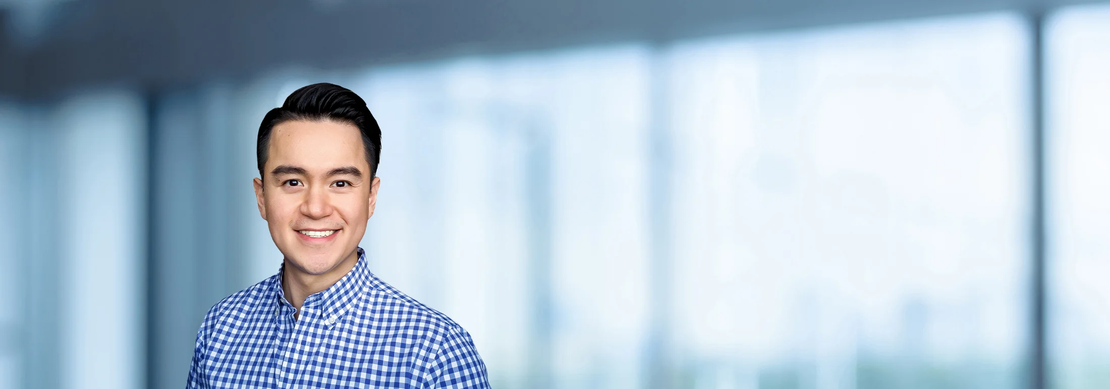 A photo of attorney, Thien Tran, against a softly blurred office background