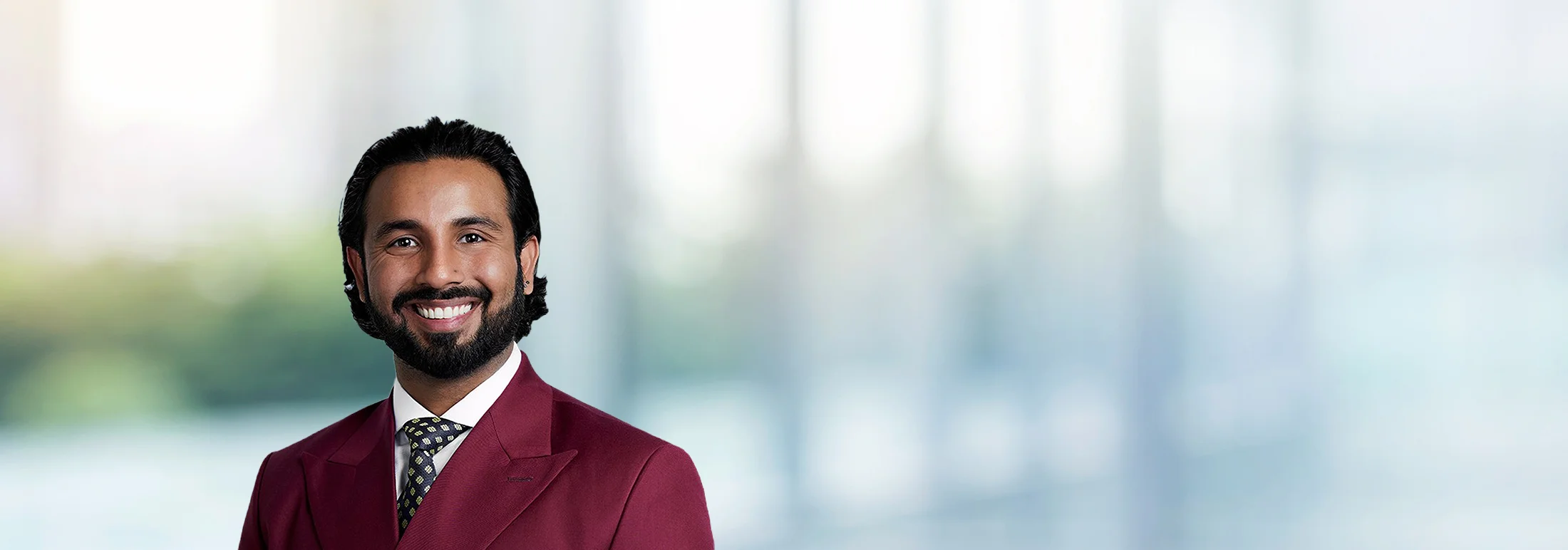 A photo of attorney Muhammad Aadil against a softly blurred office background