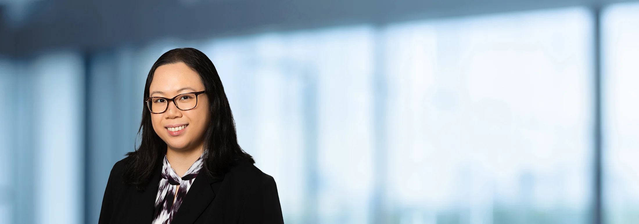 A photo of attorney Chelsea Tiong against a softly blurred office background