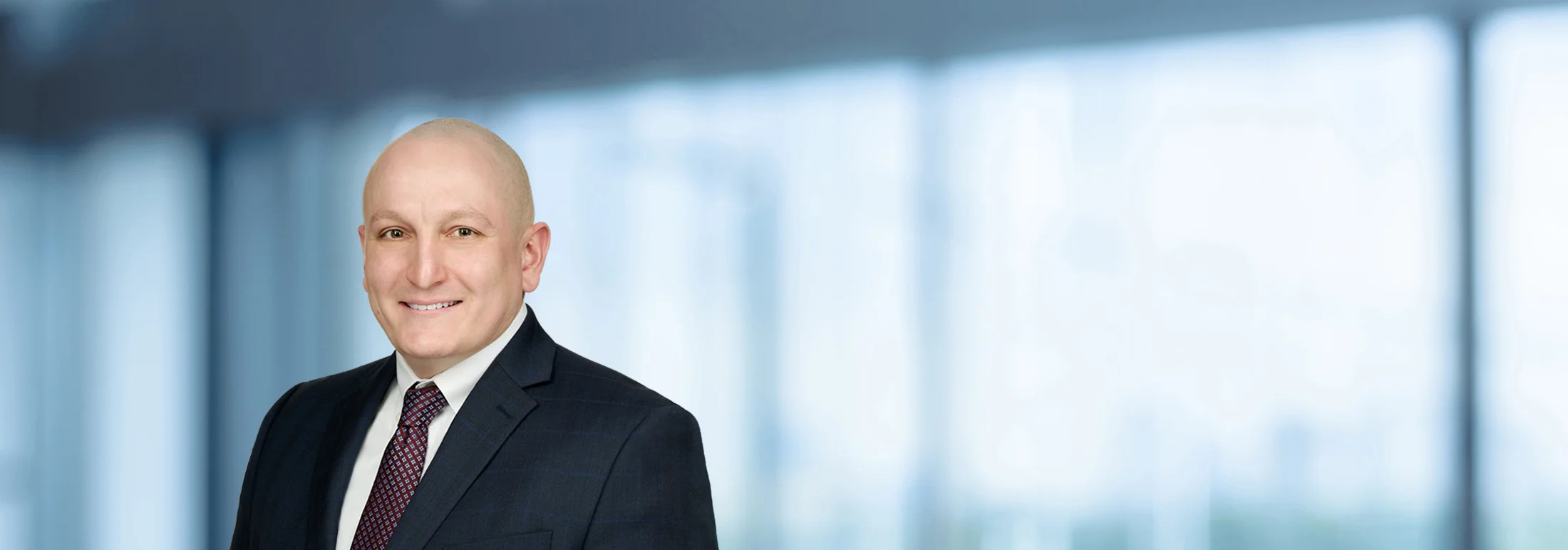 A photo of attorney James VanCamp against a softly blurred office background